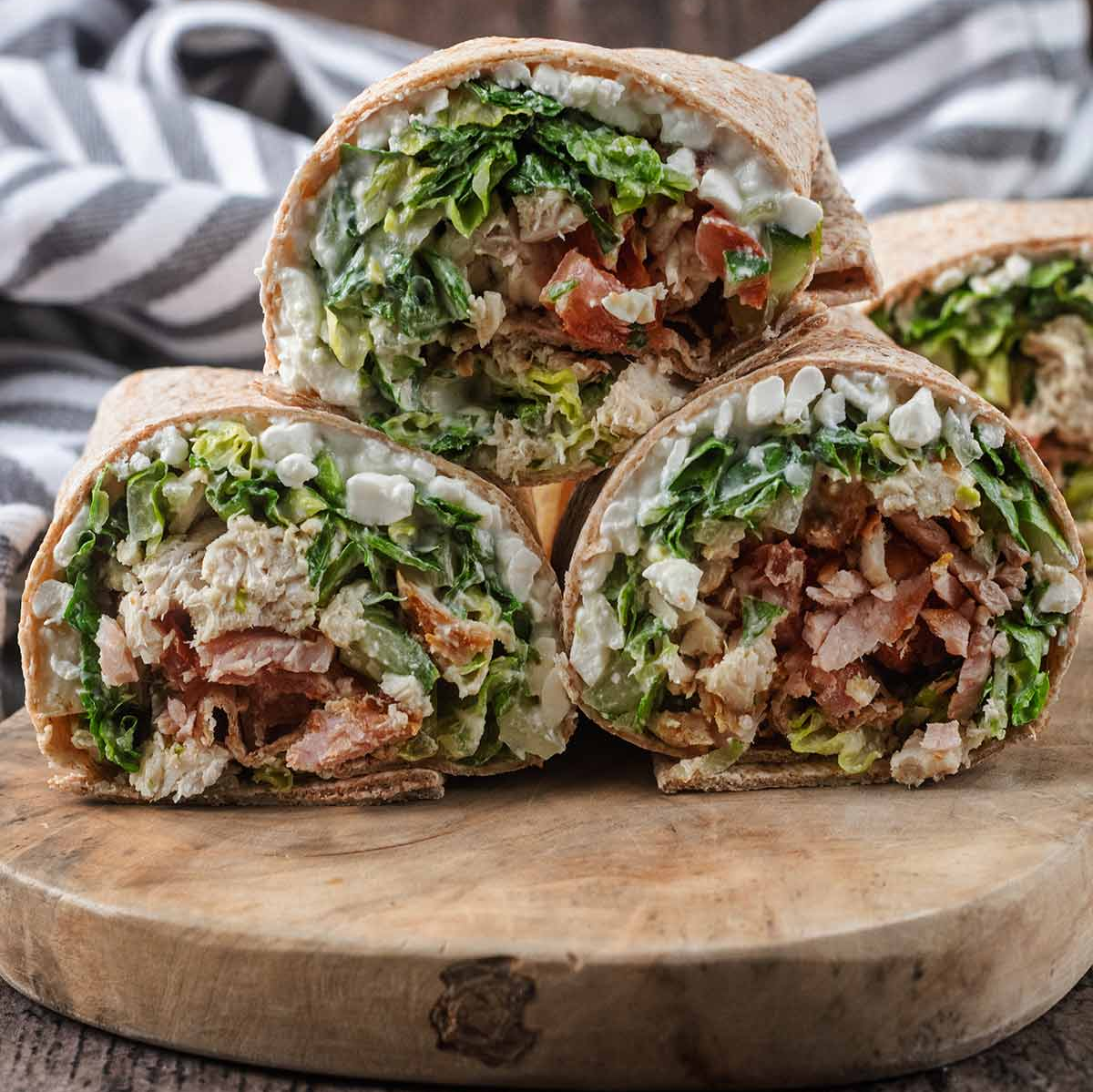 WW-Friendly Chicken Caesar Wrap A lighter take on a classic favorite, this WW-Friendly Chicken Caesar Wrap is a high-protein, satisfying lunch made with tender chicken, crispy lettuce, creamy cottage cheese, and Caesar-inspired flavors wrapped in a soft whole wheat tortilla. Recipe Card WW-Friendly Chicken Caesar Wrap (Lower Points Version) A deliciously balanced chicken wrap with classic Caesar salad flavors, extra protein, and a lighter ingredient combination that fits easily into a WW-friendly meal plan. Prep Time: 10 minutes Cook Time: 15 minutes Total Time: 25 minutes Servings: 2 wraps Dietary Highlights: WW-friendly High-protein Lower-point meal option High in lean protein Meal-prep friendly Ingredients 220 g chicken breast 1 bacon medallion 1½ heads romaine lettuce, chopped 1 portion Caesar salad dressing 2 whole wheat tortilla wraps 100 g fat-free cottage cheese 100 g cucumber, diced 2 tomatoes, diced 3 g Parmesan cheese, grated Instructions Cook the chicken breast and bacon medallion until fully cooked. Chop the chicken and bacon into small bite-sized pieces. Chop the romaine lettuce and toss with Caesar salad dressing. Warm the whole wheat tortillas briefly until soft and flexible. Spread half of the cottage cheese evenly over each tortilla. Add dressed lettuce, chicken, bacon, cucumber, tomatoes, and Parmesan. Roll each tortilla tightly, slice in half, and serve. Recipe Notes Use freshly cooked chicken for the best texture and flavor. Cottage cheese adds creaminess and extra protein while helping reduce the need for heavier sauces. For meal prep, keep the filling separate from tortillas until ready to eat to prevent sogginess. Adjust the Caesar dressing amount based on your personal WW points allowance. A Lighter Caesar Wrap That Still Feels Indulgent Classic Caesar wraps are usually packed with creamy dressing, large portions of cheese, and calorie-dense ingredients. This version keeps everything you love about the original while making a few smart swaps that help create a more balanced meal. This WW-Friendly Chicken Caesar Wrap combines juicy chicken breast, crispy romaine lettuce, smoky bacon, and a creamy cottage cheese layer for a wrap that feels satisfying instead of restrictive. It is perfect for busy lunches, quick dinners, or preparing ahead for a grab-and-go meal. The best part? You still get the familiar Caesar flavors: savory chicken, crunchy lettuce, salty Parmesan, and creamy dressing in every bite. How to Make the WW-Friendly Chicken Caesar Wrap Cook the Chicken and Bacon Start by cooking the chicken breast and bacon medallion until completely cooked through. The chicken should be tender and juicy, while the bacon should add a savory, smoky flavor throughout the wrap. For the best results, season the chicken lightly before cooking. Simple seasonings like black pepper, garlic powder, paprika, or Italian seasoning can add extra flavor without significantly changing the recipe. Once cooked, allow the chicken to rest for a few minutes before chopping. This helps keep the juices inside instead of losing moisture during cutting. Tip: Avoid overcooking chicken breast because it can become dry. Cooking just until done keeps the wrap much more enjoyable. Prepare the Caesar Lettuce Filling Chop the romaine lettuce into thin pieces so it distributes evenly throughout each wrap. Toss the lettuce with the Caesar dressing until lightly coated. The goal is not to soak the lettuce but to add enough dressing for flavor while keeping the tortilla firm. Romaine lettuce is ideal for this recipe because it stays crisp and provides the classic Caesar salad texture. Tip: If preparing ahead, store the dressed lettuce separately and mix just before assembling. Build the Wraps Warm the tortillas briefly before assembling. A slightly warm tortilla is softer, easier to roll, and less likely to crack. Spread the fat-free cottage cheese across each tortilla. This step creates a creamy base while adding extra protein to the wrap. Next, layer the Caesar lettuce mixture, chopped chicken, bacon, cucumber, tomatoes, and Parmesan. Try not to overfill the tortillas. Too many ingredients can make rolling difficult and cause the filling to spill out. Fold the sides inward, roll tightly from one end, and slice before serving. Ingredient Details and Substitution Tips Chicken Breast Chicken breast is the main protein source in this wrap. It is naturally lean, filling, and works well with bold flavors like Caesar dressing and Parmesan. For the best texture, choose fresh chicken breast and avoid cooking it at excessively high temperatures. Substitutions: Cooked turkey breast can replace chicken. Rotisserie chicken works for a faster version. Grilled chicken adds a smoky flavor. Fat-Free Cottage Cheese Cottage cheese is one of the ingredients that makes this wrap unique. Instead of relying only on dressing or mayonnaise-based sauces, cottage cheese adds creaminess and boosts protein. If you prefer a smoother texture, blend the cottage cheese before spreading it onto the tortillas. Substitutions: Low-fat cottage cheese Plain Greek yogurt Light cream cheese spread Whole Wheat Tortillas Whole wheat tortillas provide structure and additional fiber compared with traditional white tortillas. Choose tortillas that are large enough to hold the filling without tearing. Substitutions: High-protein wraps Lower-carb tortillas Gluten-free wraps if needed Romaine Lettuce Romaine creates the classic Caesar salad experience. Its crunchy texture holds up well inside wraps. For maximum freshness, use crisp green leaves and remove any wilted outer pieces. Caesar Dressing Caesar dressing provides the signature flavor. Since dressing can vary significantly in calories and WW points, choose a lighter option if needed. You can also control the amount used by lightly coating the lettuce instead of adding extra sauce. Bacon Medallion A small amount of bacon adds a lot of flavor. Using a bacon medallion keeps the smoky taste while maintaining a lighter profile. Substitutions: Turkey bacon Extra chicken Smoked chicken pieces Recipe Variations and Serving Suggestions Extra Protein Chicken Caesar Wrap For an even higher-protein version, increase the chicken breast to 300 g and add an extra 50 g of cottage cheese. The wrap will become more filling without needing larger portions. Mediterranean Chicken Wrap Swap Caesar dressing for a light yogurt-based dressing and add: 30 g diced peppers Fresh herbs A sprinkle of oregano This creates a fresh Mediterranean-inspired variation. Spicy Chicken Caesar Wrap Add: 1 teaspoon hot sauce Chili flakes Spicy seasoning on the chicken The heat pairs well with the creamy ingredients. Vegetarian Caesar Wrap Replace chicken and bacon with: Grilled mushrooms Roasted chickpeas Extra vegetables Use vegetarian Caesar dressing if needed. Gluten-Free Version To make this recipe gluten-free: Use certified gluten-free tortillas. Check that your dressing and seasonings are gluten-free. The filling itself can easily fit a gluten-free eating pattern. Serving Suggestions This wrap makes a complete lunch on its own, but you can pair it with lighter sides for a larger meal. Good options include: Fresh fruit Vegetable sticks with yogurt dip A small side salad Roasted vegetables A cup of soup For drinks, sparkling water with lemon, iced tea, or a light coffee pairs well with the fresh Caesar flavors. Storage and Make-Ahead Instructions Refrigerator Storage Prepared wraps are best enjoyed fresh, but they can be stored for short periods. Wrap assembled leftovers tightly in foil or reusable food wrap and refrigerate for up to 24 hours. For the best texture, store: Chicken separately Lettuce mixture separately Tortillas separately Then assemble when ready. Meal Prep Tips This recipe works well for meal preparation. Prepare the following ahead: Cook and chop chicken Cook bacon Dice vegetables Portion cottage cheese Store ingredients separately in airtight containers. When ready to eat, assemble the wrap fresh in just a few minutes. Freezing Freezing is not recommended because lettuce, cucumber, and cottage cheese can change texture after thawing. Nutrition Information Approximate nutrition per wrap: Calories: 350–400 kcal Protein: 35–40 g Carbohydrates: 30–35 g Fat: 10–14 g Nutrition will vary depending on the tortilla size and Caesar dressing brand used. Dietary Highlights: High protein Balanced carbohydrates Lower-point friendly option Contains lean protein and vegetables Allergens: Milk (cottage cheese, Parmesan, Caesar dressing) Wheat/gluten (whole wheat tortillas) Eggs and fish may be present depending on Caesar dressing ingredients Frequently Asked Questions Can I use leftover chicken for this wrap? Yes. Cooked leftover chicken works very well. Simply chop or shred it before assembling the wraps. Can I make this WW-Friendly Chicken Caesar Wrap ahead of time? Yes, but keeping the ingredients separate until serving gives the best texture. The tortilla can become soft if stored too long with dressed lettuce. Can I replace cottage cheese if I do not like it? Yes. Blended Greek yogurt or a light cream cheese spread can provide a similar creamy texture. How can I reduce the WW points further? You can reduce points by: Choosing a lower-point tortilla Using less dressing Increasing vegetables Choosing a lighter Caesar dressing Can I use chicken thighs instead of breast? Yes, but chicken breast keeps this recipe leaner and higher in protein per calorie. If using thighs, choose skinless chicken thighs. Why is my wrap falling apart? This usually happens when the tortilla is overfilled. Use moderate portions, fold the sides inward, and roll tightly. Final Thoughts This WW-Friendly Chicken Caesar Wrap proves that lighter meals can still be satisfying and full of flavor. The combination of protein-rich chicken, creamy cottage cheese, crunchy vegetables, and classic Caesar seasoning creates a lunch that feels like a treat while supporting balanced eating goals. Whether you are preparing weekday lunches, looking for a quick dinner, or simply want a healthier twist on a restaurant-style wrap, this recipe is an easy option to keep in your regular rotation. Try it with your favorite wrap additions and share your version. If you make this recipe, let others know what variations you enjoyed most.